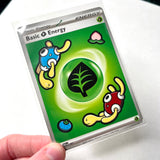 A collectible Pokémon trading card showing the 'Basic Energy' card encased in a clear protective plastic sleeve and held by a hand against a white background.