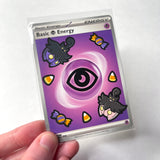 A Pokemon energy card with Pumpkaboos and Halloween candy painted on.