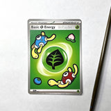 A single Pokémon trading card titled "Basic Energy" featuring WolfJayden, shown on a light gray surface with a paintbrush partially visible at the right edge.